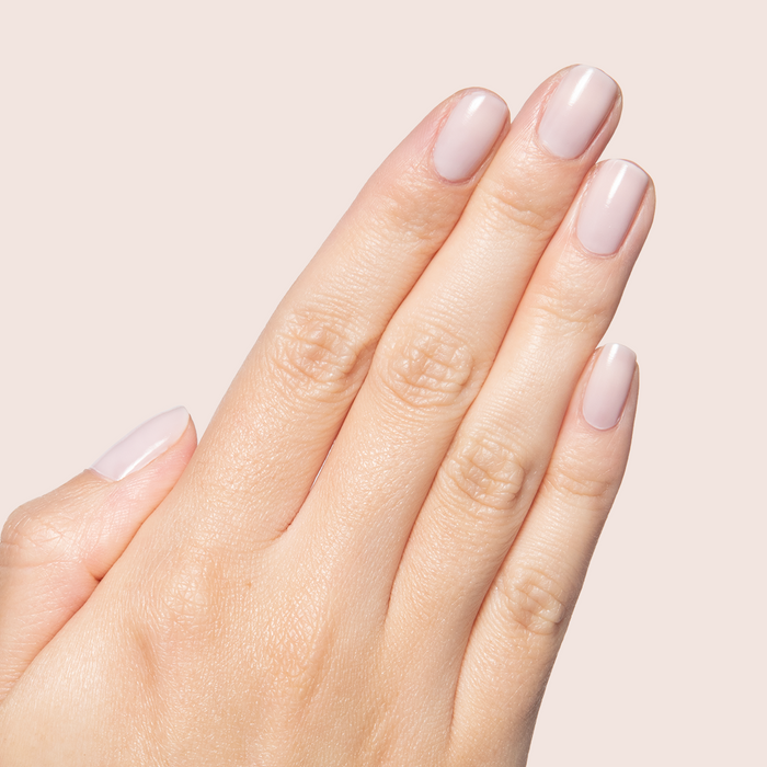 Extra Marshmallows gel polish on short nails showing a sheer cool toned grey lavender manicure by Olive and June