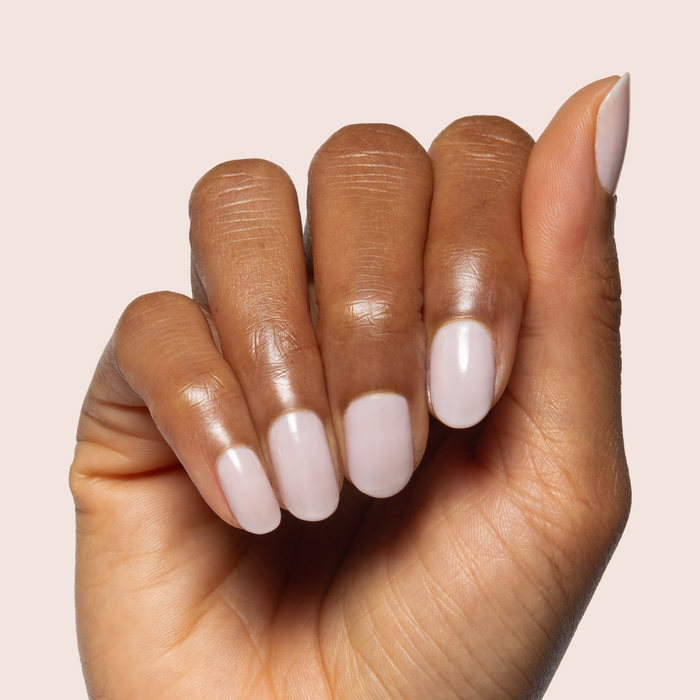 Extra Marshmallows gel polish on natural nails showing a soft sheer grey lavender manicure by Olive and June