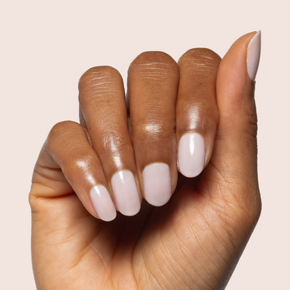 Extra Marshmallows gel polish on natural nails showing a soft sheer grey lavender manicure by Olive and June