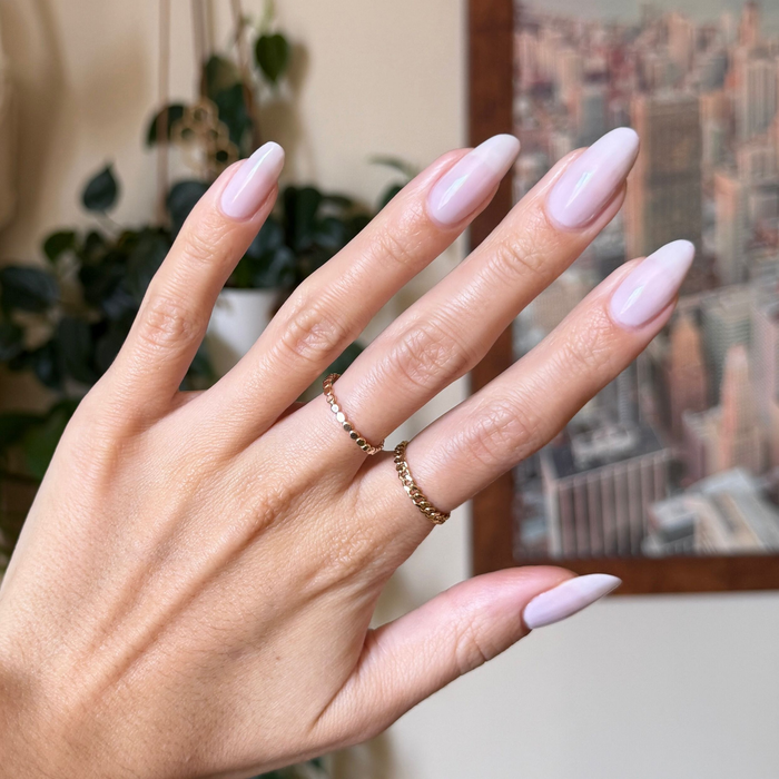 Extra Marshmallows gel polish on long almond-shaped nails showing a sheer cool toned manicure by Olive and June