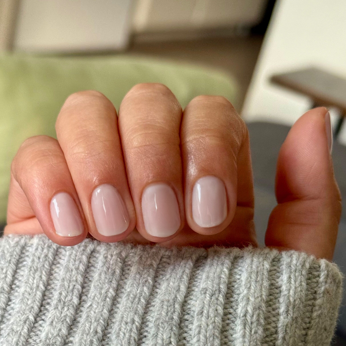 Extra Marshmallows gel polish on natural short nails showing a sheer grey lavender manicure by Olive and June