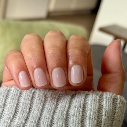 Extra Marshmallows gel polish on natural short nails showing a sheer grey lavender manicure by Olive and June