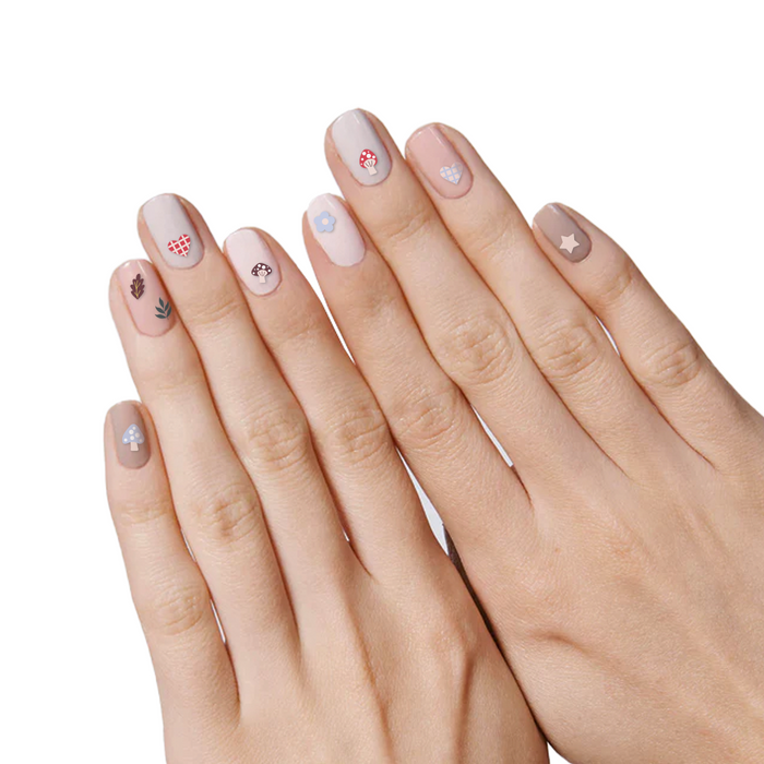 Fall Elements nail art stickers with mushrooms, flowers, and leaves on natural nude manicure by Olive and June