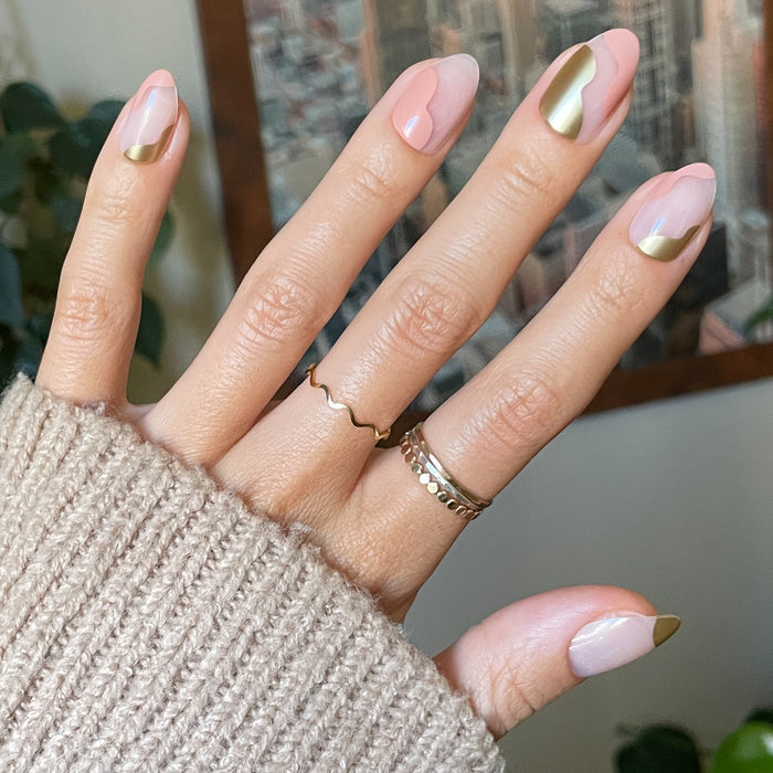 Fall Groovy Swirl - Press-On | Medium | Almond nails with soft pink and metallic gold accent design on hand with cozy sweater
