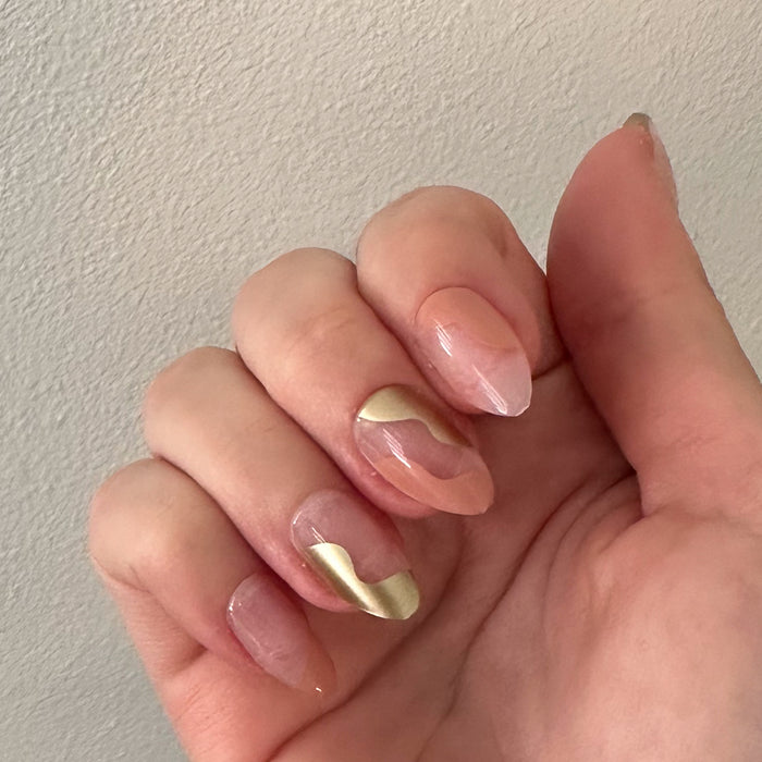 Fall Groovy Swirl - Press-On | Medium | Almond nails with peach base and metallic gold groovy swirl design on natural hand