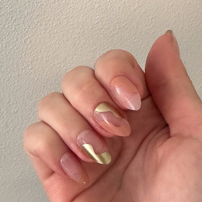 Fall Groovy Swirl - Press-On | Medium | Almond nails with peach base and metallic gold groovy swirl design on natural hand