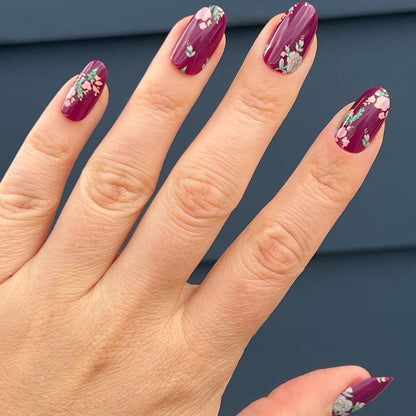 Fall Micro Floral | Oval | Medium press-on nails in deep berry with delicate floral accents for an easy at-home manicure