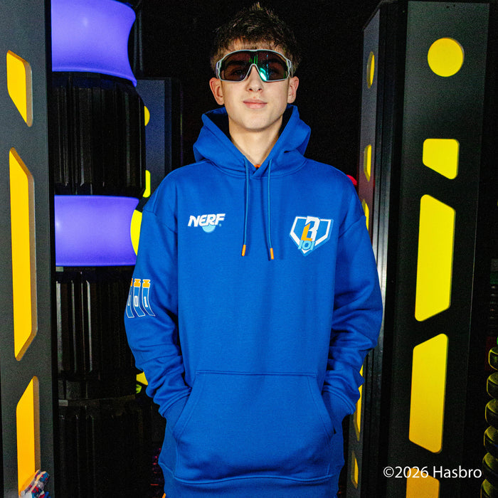 Person wearing a blue hoodie with a NERF X BL101 logo, standing in front of colorful geometric background