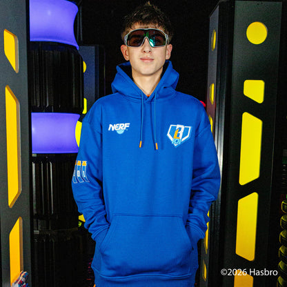 Person wearing a blue hoodie with a NERF X BL101 logo, standing in front of colorful geometric background