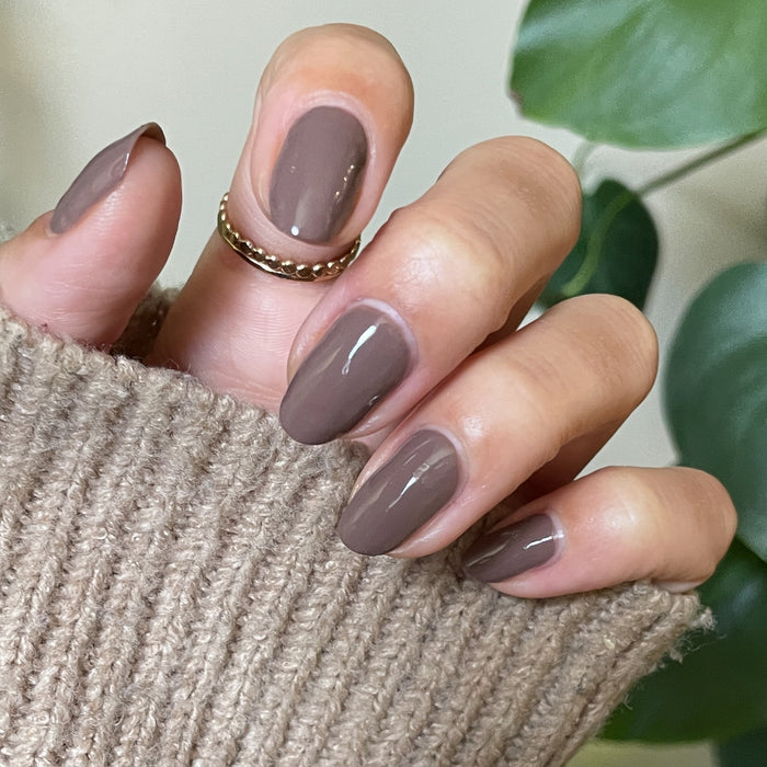 Hand with Fawn gel polish in a muted brown neutral shade for a smooth, long-lasting at-home mani look