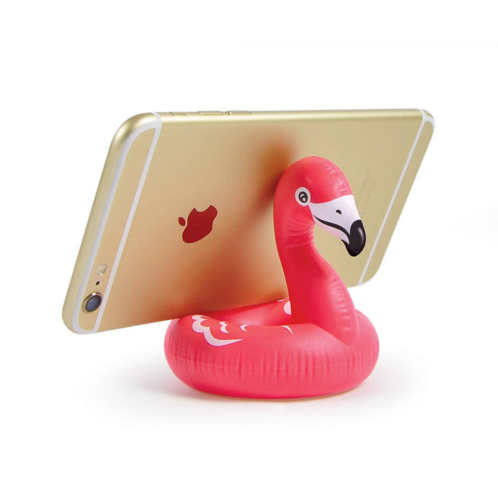 Fred & Friends Float on flamingo phone stand holding a smartphone in a playful design.
