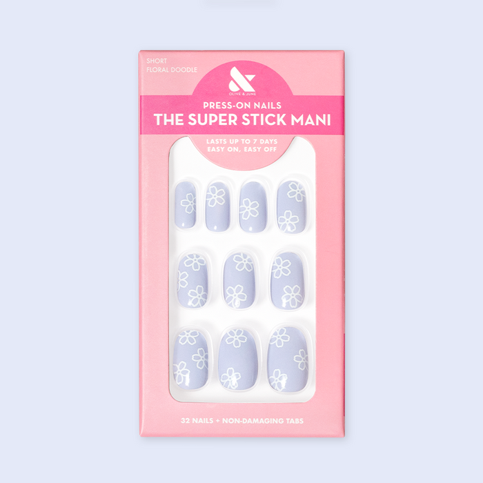 Floral Doodle | Short | Round - Tab Press-On nails in pastel blue with white floral doodles displayed in retail packaging
