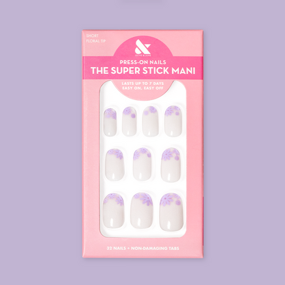 Floral Tip | Short | Round - Tab Press-On nails with neutral base and lavender flower tips in retail pink packaging