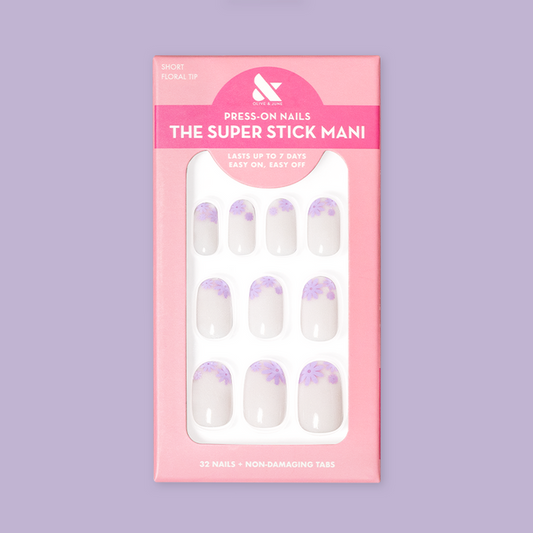 Floral Tip | Short | Round - Tab Press-On nails with neutral base and lavender flower tips in retail pink packaging
