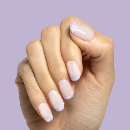 Floral Tip | Short | Round - Tab Press-On nails with soft neutral base and small lavender flowers on tips against lavender background