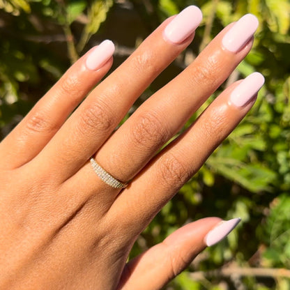 Gelato | Short | Round - Tab Press-On long soft baby pink press-on nails with smooth glossy finish on sunlit hand outdoors