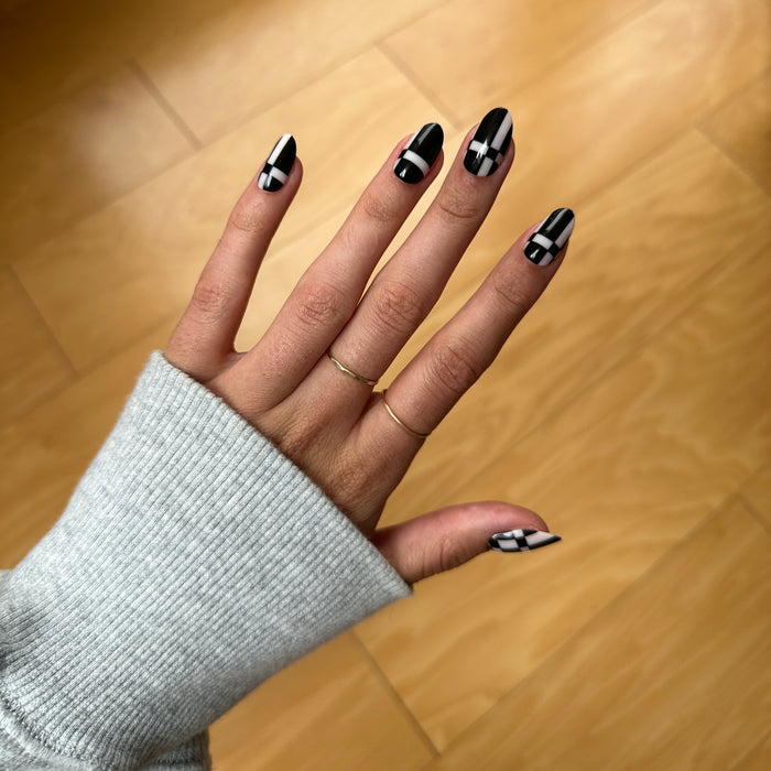 Geometric Plaid | Medium | Oval - Tab Press-On showing black and white geometric patterned medium oval press-on nails for at home mani