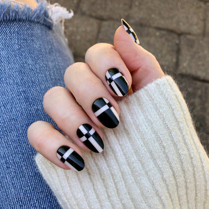 Geometric Plaid | Medium | Oval - Tab Press-On showing black oval nails with white plaid design for easy at home manicure