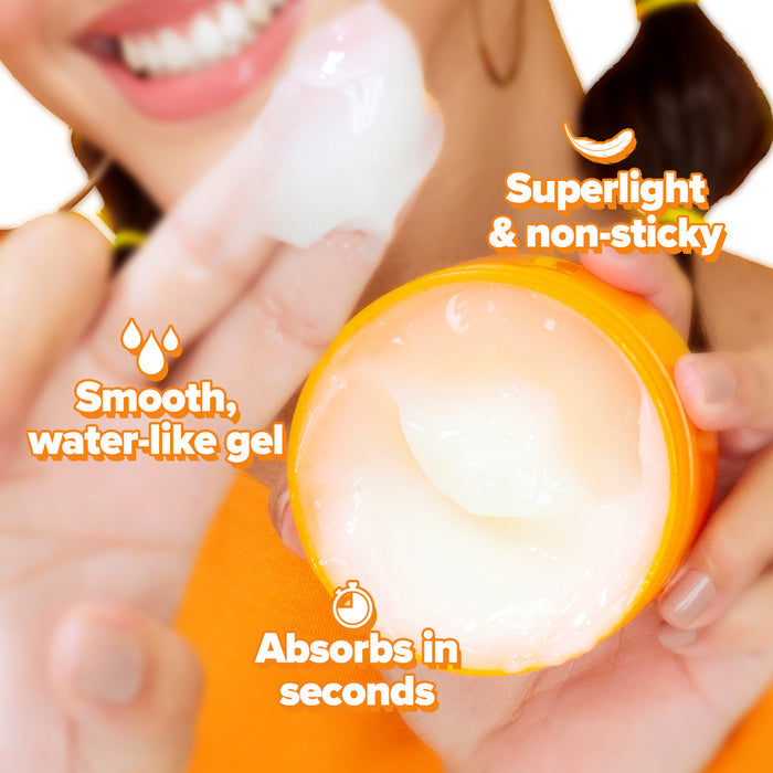 Hand scooping papaya moisturizer with smooth gel-cream texture