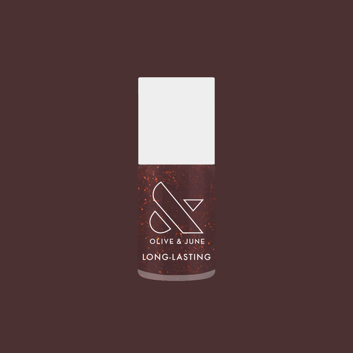 Bottle of Goal Getter long-lasting gel polish in a shimmering chocolatey brown shade on a deep mauve background