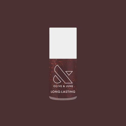 Bottle of Goal Getter long-lasting gel polish in a shimmering chocolatey brown shade on a deep mauve background