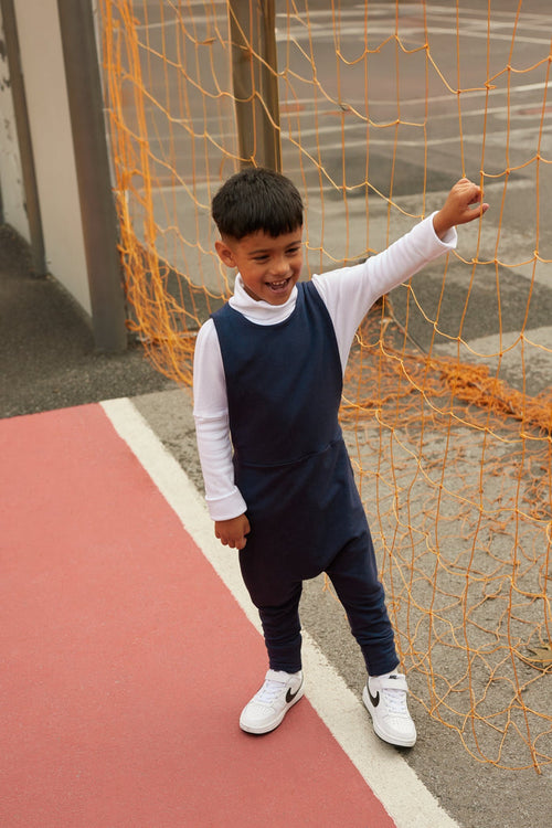 navy grow-with-me overalls for toddlers and kids, made from soft, eco-friendly fabric. Adjustable straps and cuffs for a long-lasting fit. Ethically made in Canada.