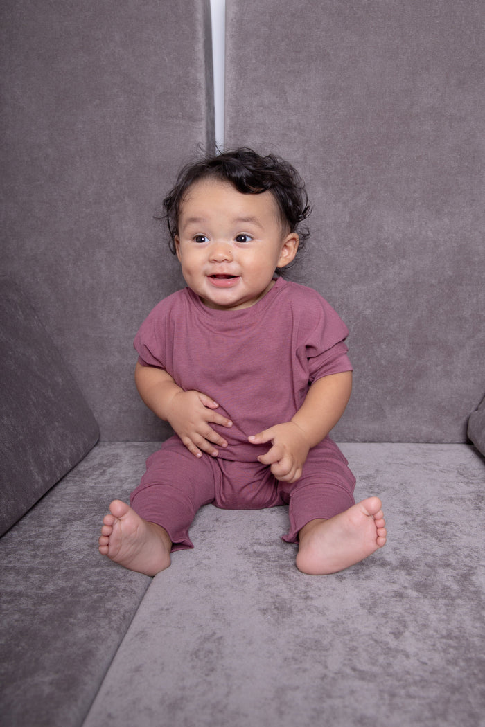 Rose brown grow-with-me pants for toddlers and kids, made from soft, eco-friendly fabric. Adjustable waistband and cuffs for extended wear. Ethically made in Canada.