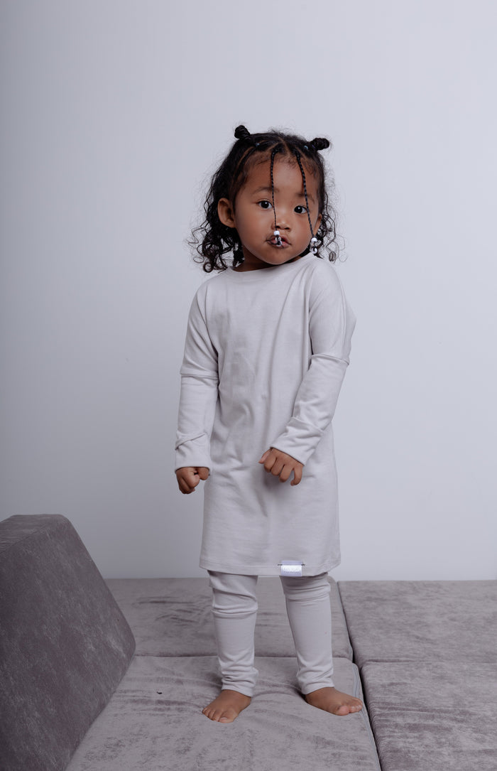 Taupe grow-with-me shirt for toddlers and kids, designed to be worn as a dress, tunic, or long shirt. Seamless shoulders and soft, eco-friendly fabric. Ethically made in Canada.