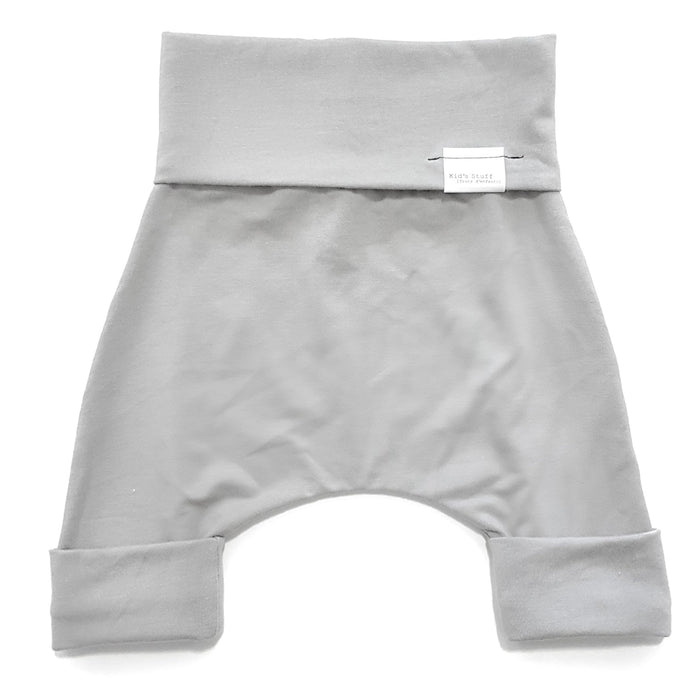 Taupe grow-with-me shorts for kids, made from soft organic cotton with a stretchy, foldable waistband. Ethically made in Canada for a sustainable and comfy fit.