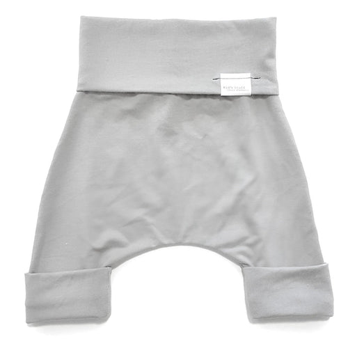 Taupe grow-with-me shorts for kids, made from soft organic cotton with a stretchy, foldable waistband. Ethically made in Canada for a sustainable and comfy fit.