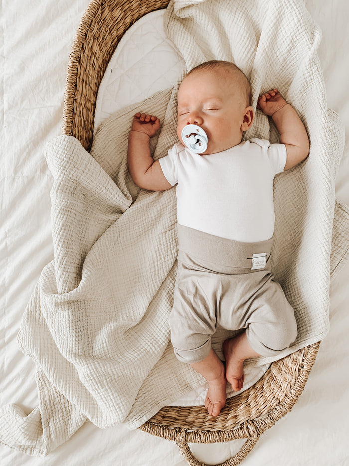 Taupe grow-with-me shorts for kids, made from soft organic cotton with a stretchy, foldable waistband. Ethically made in Canada for a sustainable and comfy fit.
