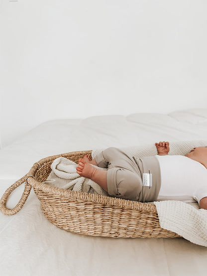 Taupe grow-with-me shorts for kids, made from soft organic cotton with a stretchy, foldable waistband. Ethically made in Canada for a sustainable and comfy fit.