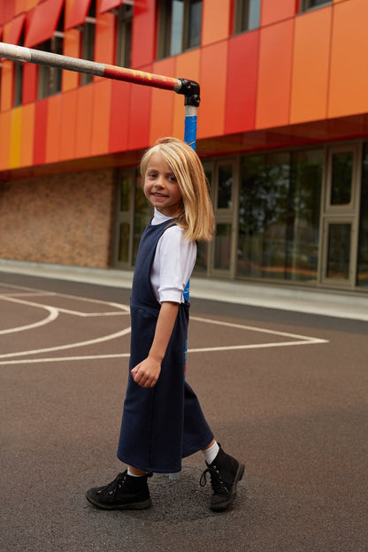 White grow-with-me t-shirt for kids, made from soft organic cotton with a stretchy, foldable waistband. Ethically made in Canada for a sustainable and comfy fit.