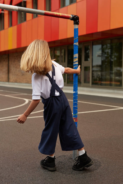 White grow-with-me t-shirt for kids, made from soft organic cotton with a stretchy, foldable waistband. Ethically made in Canada for a sustainable and comfy fit.