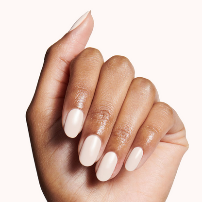 Hand with nails polished in HGC creamy toasted neutral shade for a warm, long-lasting manicure look