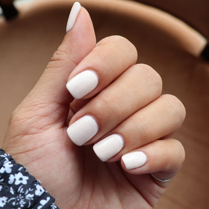 Hand with nails painted in HGC creamy toasted neutral shade for a soft, warm, and long-lasting manicure look