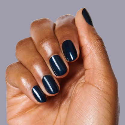Fingernails painted with HJ in shimmering inky navy showing a smooth, long-lasting manicure on dark skin tone