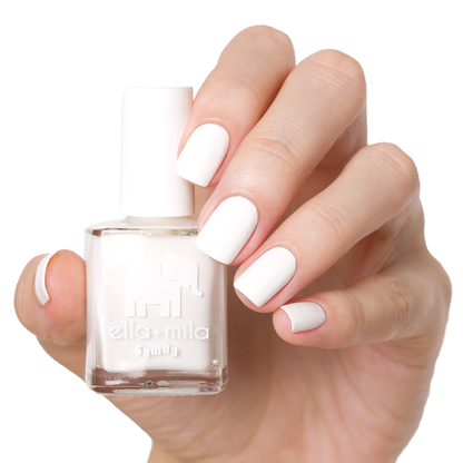 I Need a Tan snow white nail polish manicure on a light skin tone with the bottle