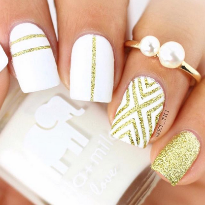 I Need a Tan white nail polish with gold glitter and stripe accent nail art, pearl ring