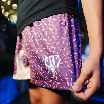 Adult model wearing purple Ice Cream Cosmic Cone Crunch shorts
