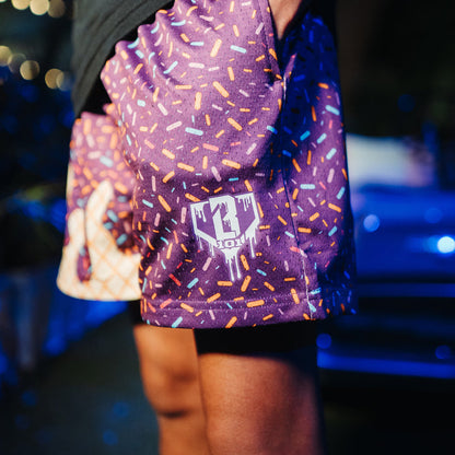 Adult model wearing purple Ice Cream Cosmic Cone Crunch shorts