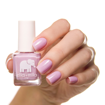 Isla View lavender pink shimmer nail polish on a medium skin tone, hand holding the bottle