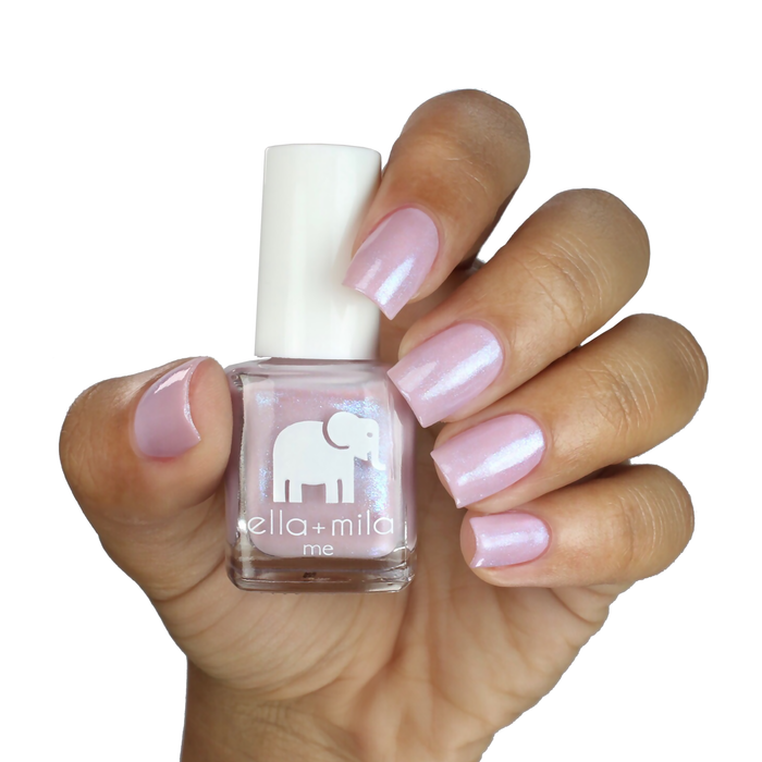 Isla View lavender pink nail polish on a deep skin tone, hand holding the bottle