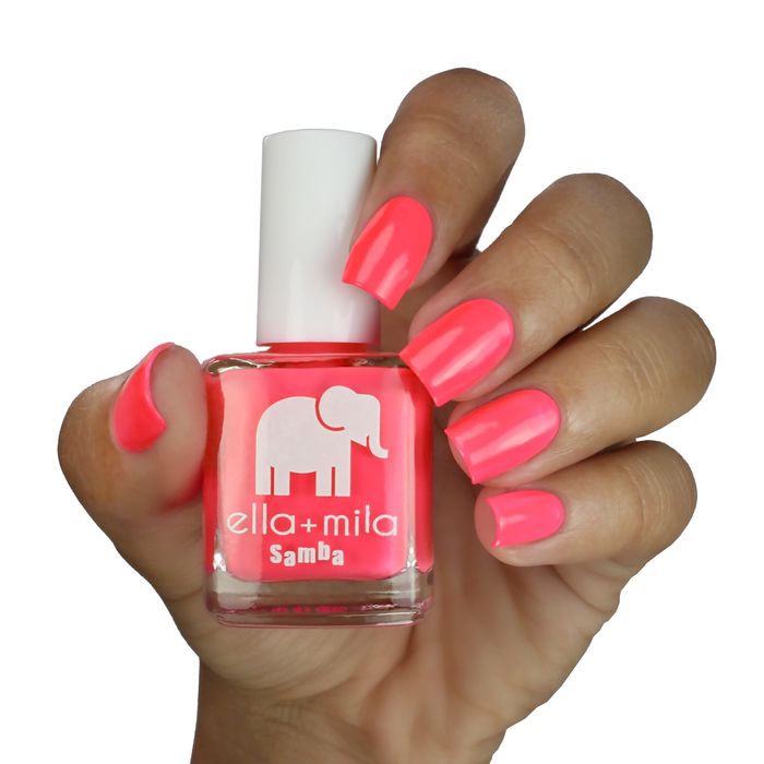 Island Love vibrant pink nail polish on a medium skin tone, hand holding the bottle
