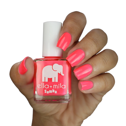 Island Love vibrant pink nail polish on a medium skin tone, hand holding the bottle