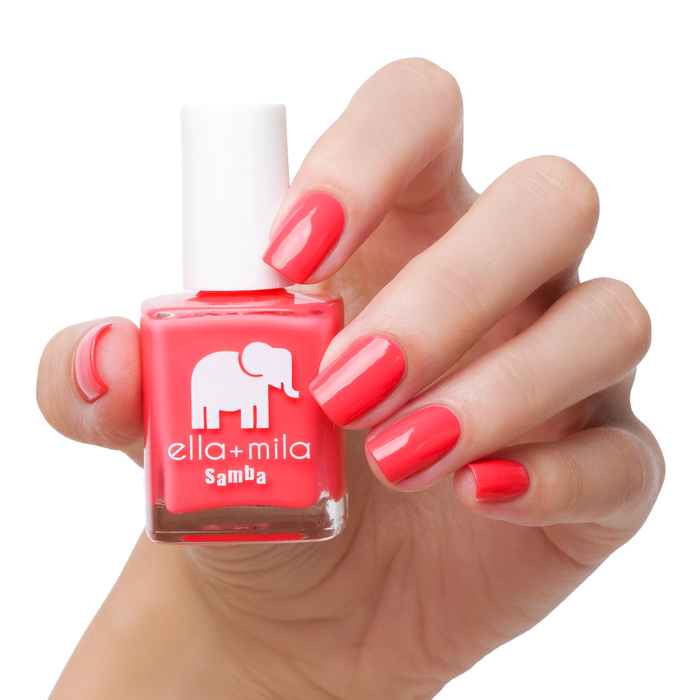 Island Love bright pink nail polish manicure on a light skin tone with the bottle