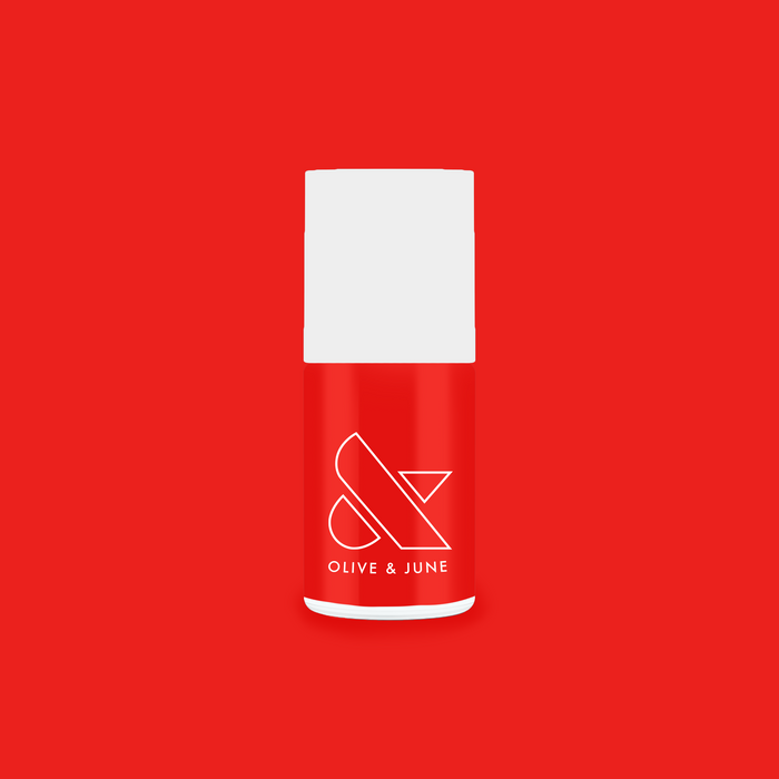 Olive and June Kiss Cam nail polish bottle in bright cranberry red for a vibrant long-lasting mani and pedi polish