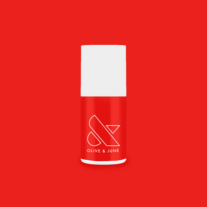 Olive and June Kiss Cam nail polish bottle in bright cranberry red for a vibrant long-lasting mani and pedi polish