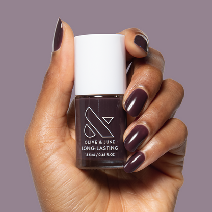 Let's Stay In gel polish on nails showing ultra dark maroon-brown for a cozy, long-lasting at-home manicure by Olive and June
