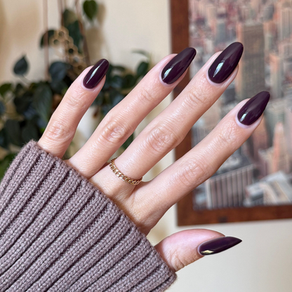 Let's Stay In gel polish on almond-shaped nails displaying a rich dark maroon-brown manicure by Olive and June